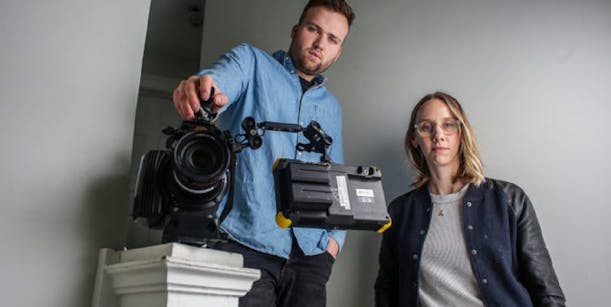 Film professionals from Means TV with a camera on a stabilizer rig, representing a behind-the-scenes look at film production and equipment handling for the 'MEANS TV' project or educational platform