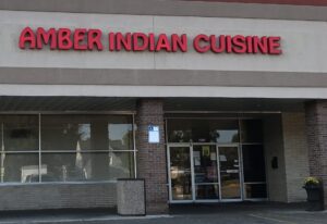 a restaurant called amber indian cuisine on a street corner