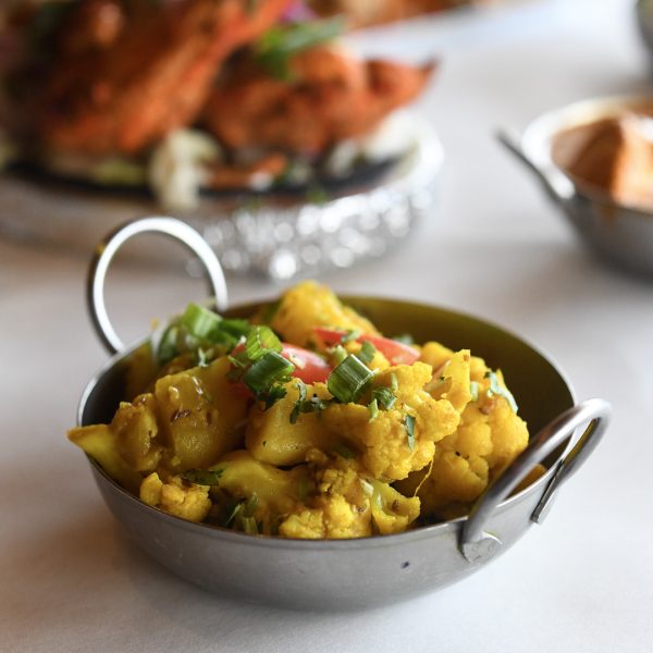 Two bowls of food on a table.