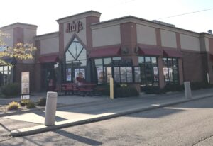 a restaurant with a red and white awning