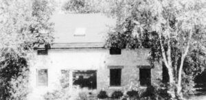 a black and white photo of an old house