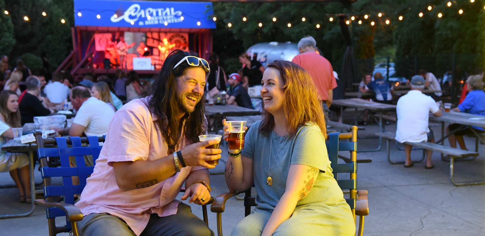 a man and a woman sitting at a table with drinks