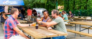 a group of people sitting at picnic tables