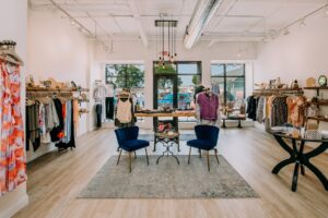 a clothing store with two chairs and a table