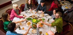 a group of people sitting around a table eating food