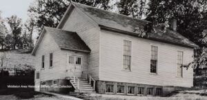 a black and white photo of an old house