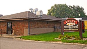 a brick building with a sign in front of it