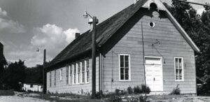 a black and white photo of a small church