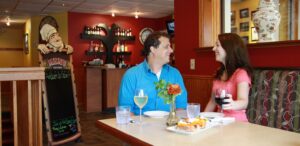 a man and a woman sitting at a table in a restaurant