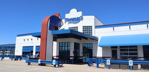 a building that has a blue and red bench outside of it.