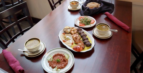 a wooden table topped with plates of food.