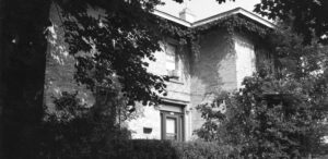 a black and white photo of an old house