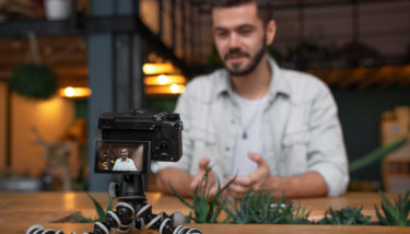 A man records himself talking to the camera, indicating he might be doing a live stream on YouTube statistics.